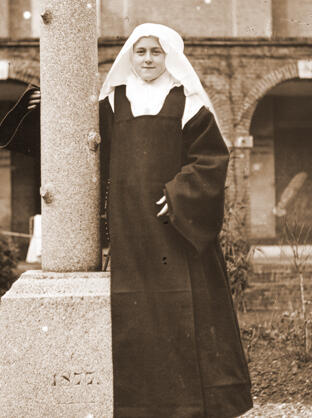 St. Thérèse of Lisieux stands for a portrait in the cloister garden.